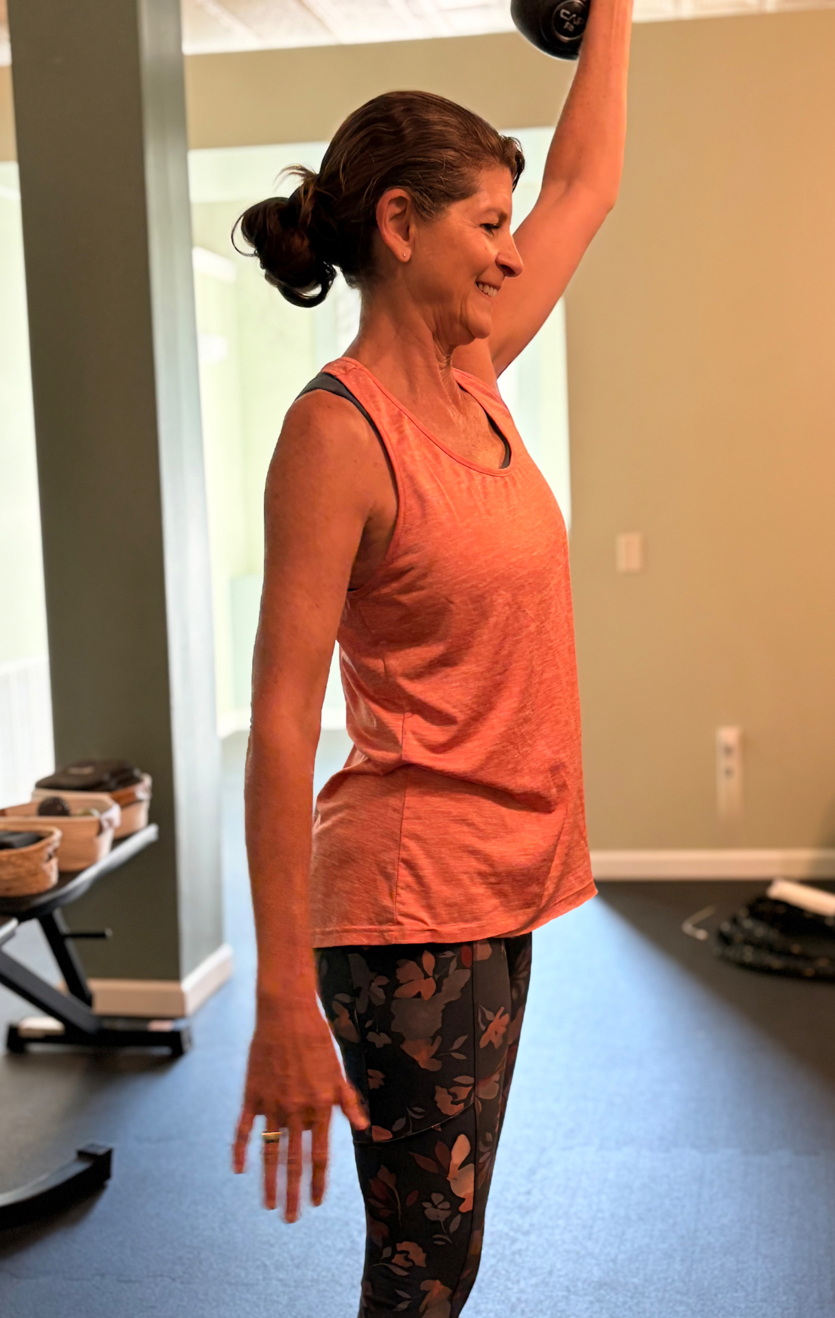 Client pressing a dumbbell overhead